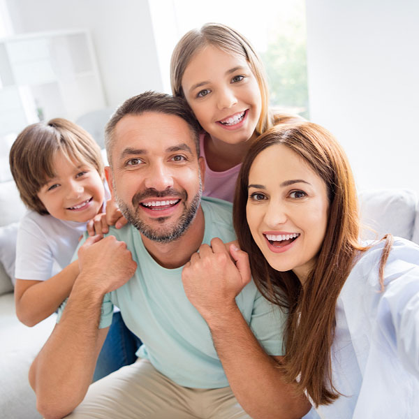 Happy family looking at the camera